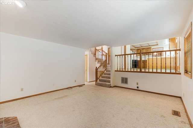 20916 SW Siletz Ct, Tualatin, OR 97062 - unfurnished living room featuring carpet and stairway
