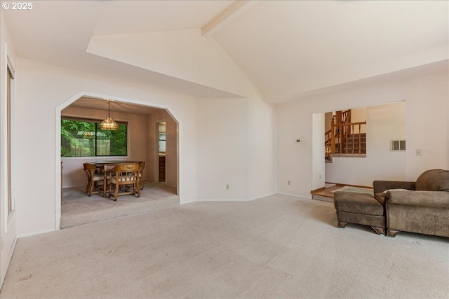 20916 SW Siletz Ct, Tualatin, OR 97062 - living area with arched walkways, beam ceiling, carpet floors, and high vaulted ceiling