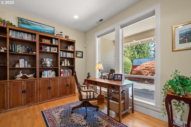 office featuring recessed lighting, visible vents, and light wood-type flooring