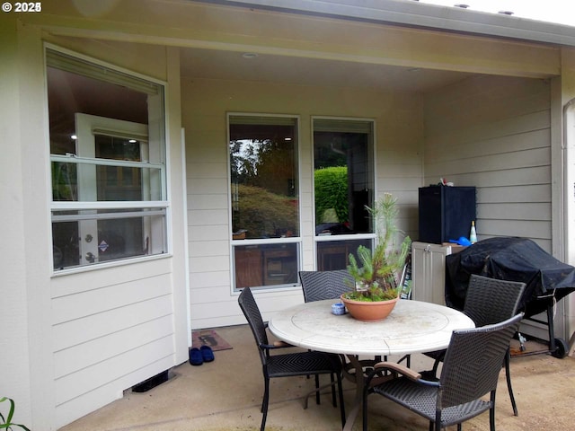 view of patio / terrace featuring outdoor dining space and a grill