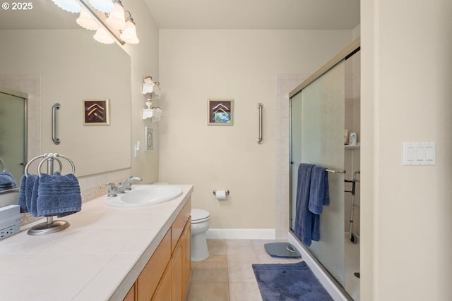 full bathroom featuring baseboards, toilet, a shower stall, vanity, and tile patterned flooring