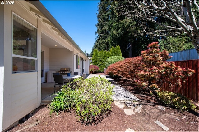 view of yard with fence and a patio