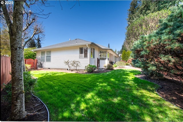 back of house with a yard and fence