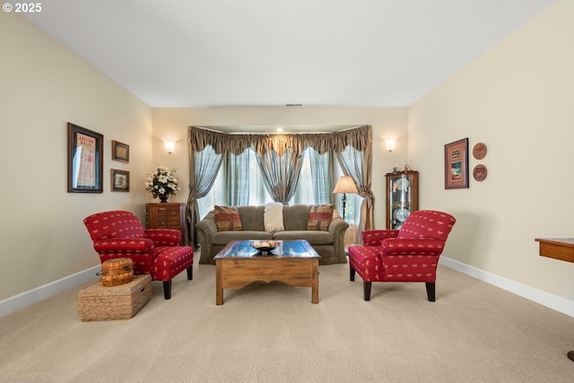 living area featuring visible vents, baseboards, and carpet