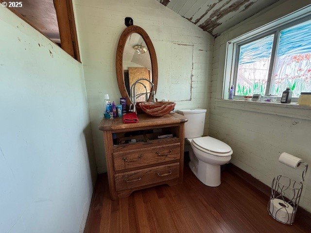 65748 Meissner Rd, Deer Island, OR 97054 - half bath with toilet, wood finished floors, lofted ceiling, and vanity
