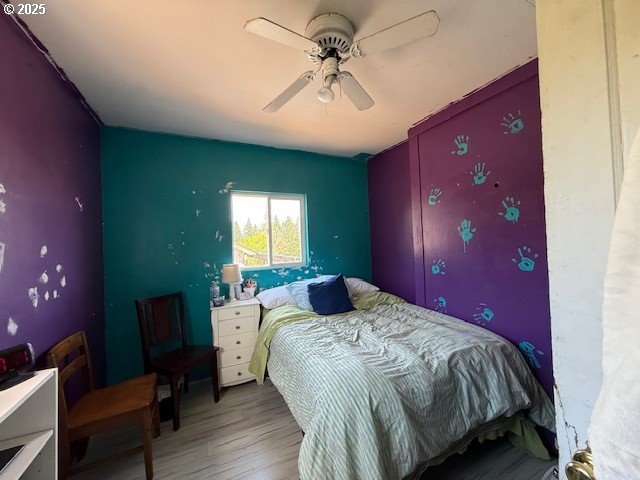 65748 Meissner Rd, Deer Island, OR 97054 - bedroom featuring wood finished floors and a ceiling fan