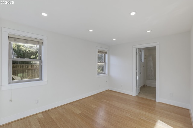 unfurnished room with a wealth of natural light and light hardwood / wood-style flooring