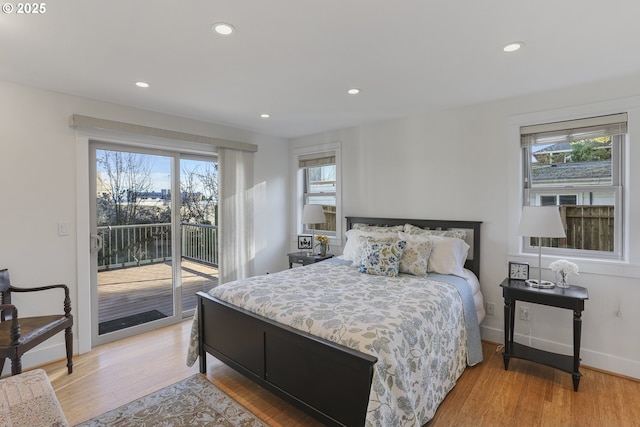 bedroom featuring light wood-type flooring and access to exterior