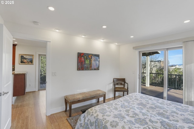 bedroom with light hardwood / wood-style flooring, multiple windows, and access to exterior