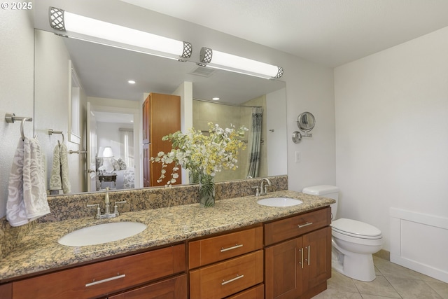 bathroom with tile patterned floors, a shower with shower door, vanity, and toilet