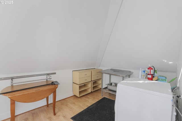 laundry area with light hardwood / wood-style flooring