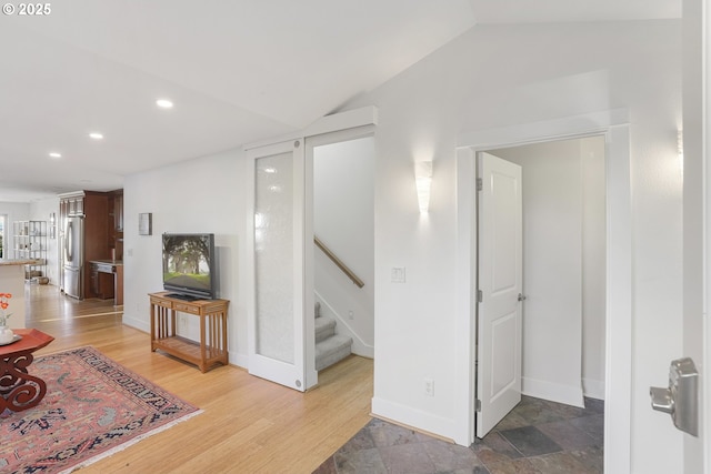 interior space with hardwood / wood-style floors and lofted ceiling