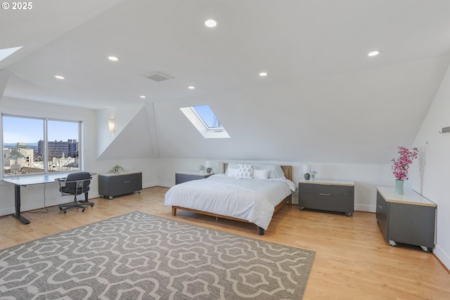 bedroom with light hardwood / wood-style floors and vaulted ceiling