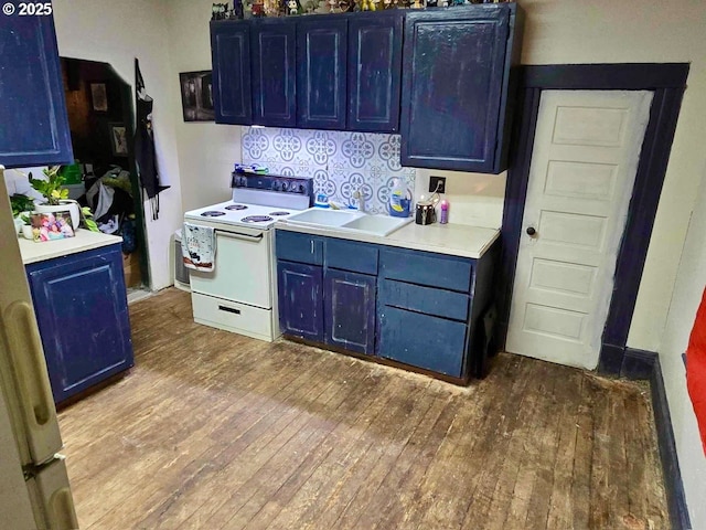 kitchen featuring wood-type flooring, blue cabinetry, sink, and white range with electric cooktop