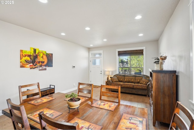 dining room featuring baseboards, light wood-type flooring, and recessed lighting