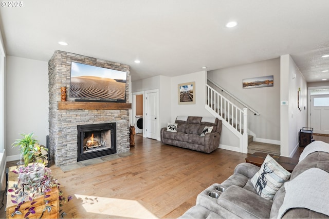 living room featuring recessed lighting, stairway, baseboards, and wood finished floors