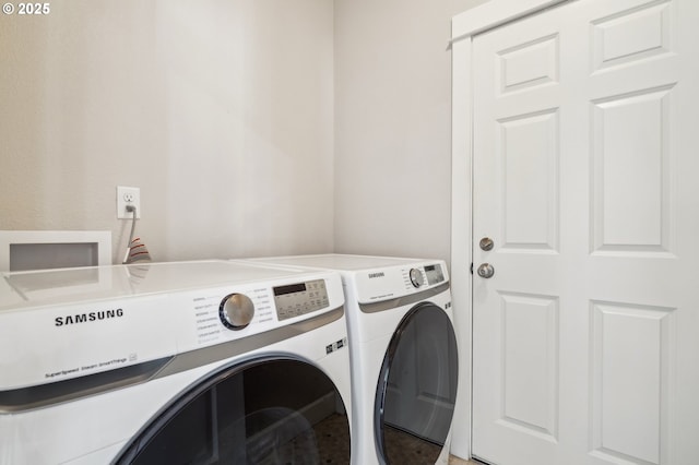 washroom with washing machine and clothes dryer and laundry area