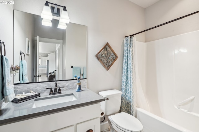 bathroom featuring toilet, tasteful backsplash, vanity, and shower / tub combo