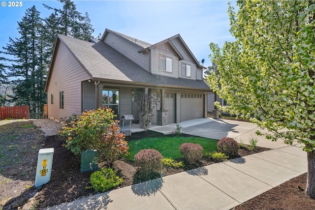 craftsman-style home with a shingled roof, driveway, a garage, and fence