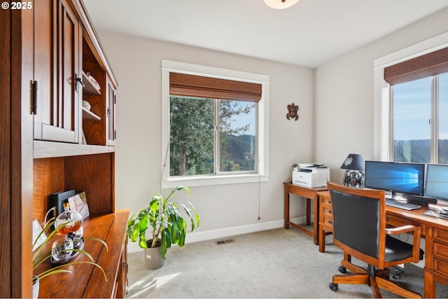 carpeted office with baseboards and visible vents