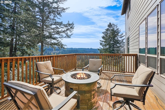 wooden deck with an outdoor fire pit