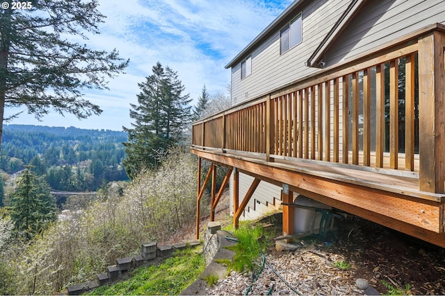 wooden deck with a forest view