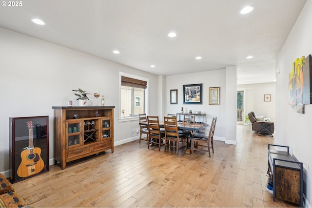 dining space with light wood-style floors and recessed lighting