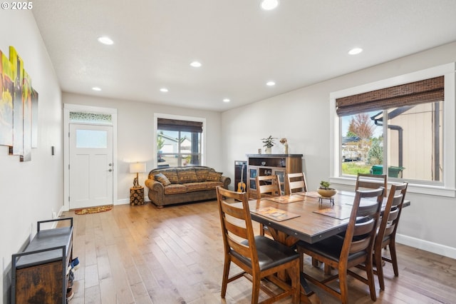 dining space with hardwood / wood-style floors, baseboards, and recessed lighting