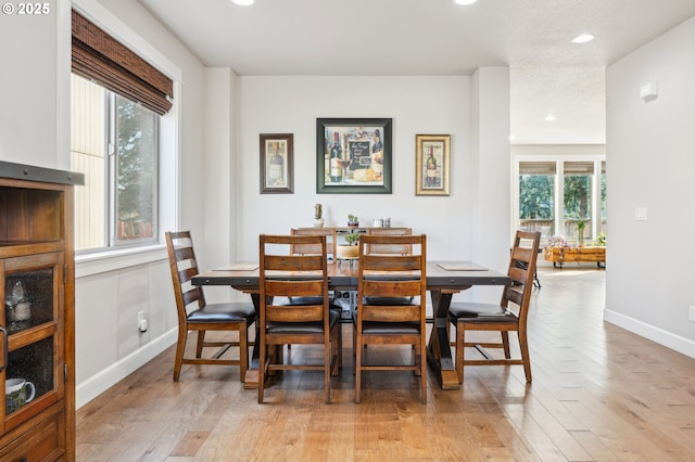 dining space with light wood-style floors, baseboards, and recessed lighting