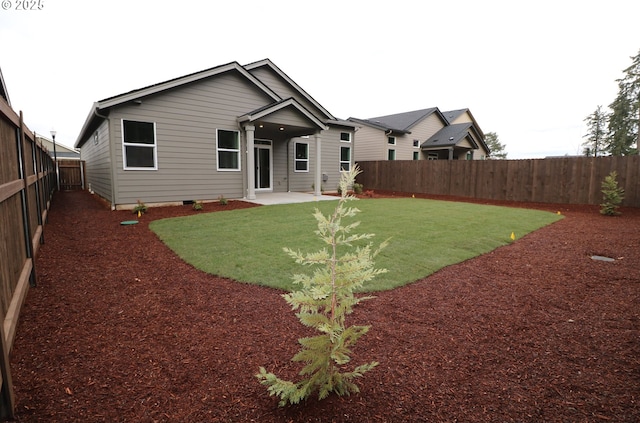 back of property featuring a patio area and a lawn