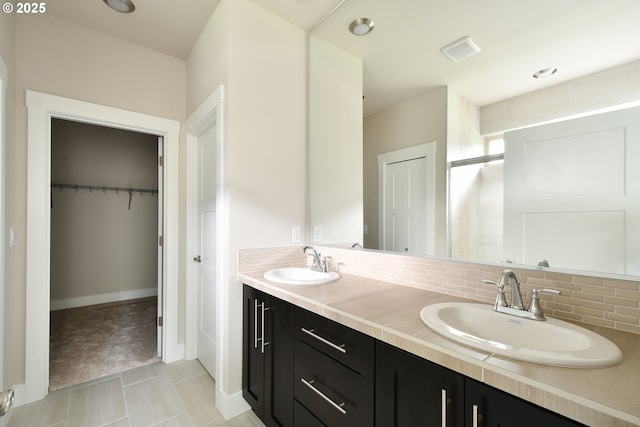 bathroom featuring tasteful backsplash and vanity