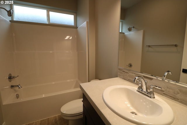 full bathroom featuring vanity, decorative backsplash, bathtub / shower combination, and toilet