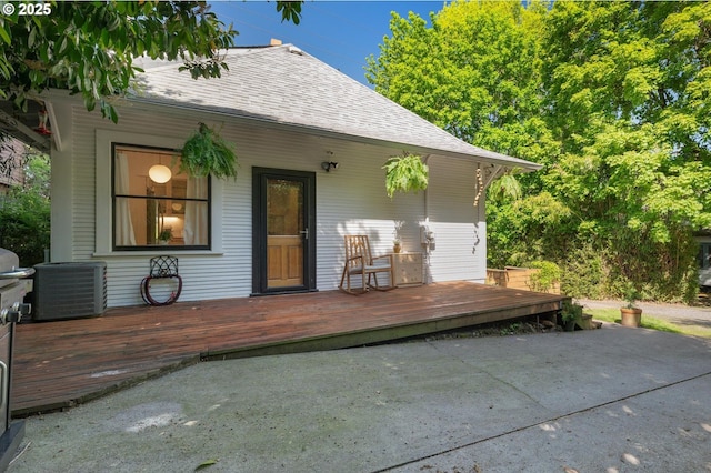 back of house with central AC, a shingled roof, a patio area, and a wooden deck