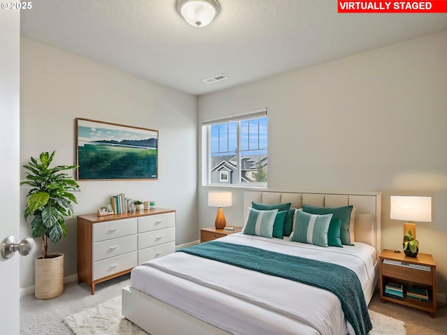 bedroom featuring light colored carpet