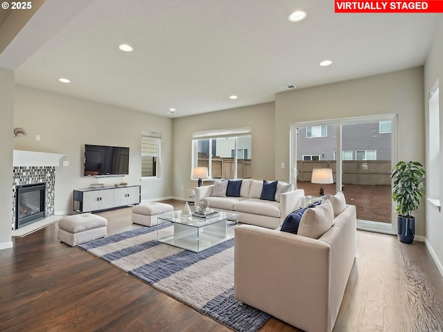 living room featuring wood-type flooring and a fireplace