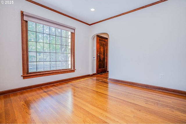 spare room with crown molding and light hardwood / wood-style floors