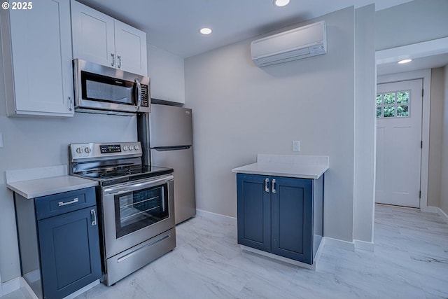 kitchen featuring white cabinetry, appliances with stainless steel finishes, blue cabinets, and a wall mounted air conditioner