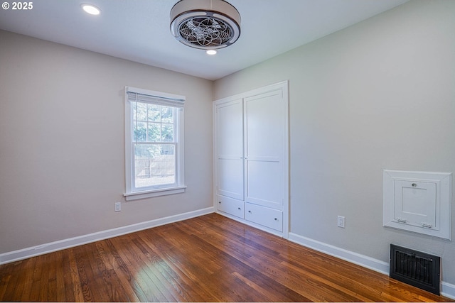 unfurnished bedroom featuring dark hardwood / wood-style flooring