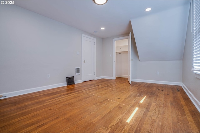 bonus room featuring lofted ceiling and hardwood / wood-style floors