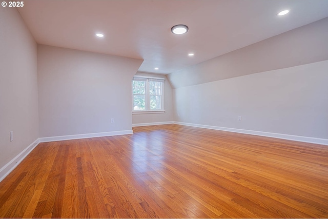 additional living space with lofted ceiling and light wood-type flooring