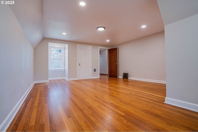 interior space with lofted ceiling and light hardwood / wood-style floors