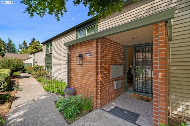 property entrance featuring brick siding
