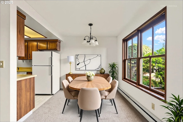 12665 SW Prince Edward Ct Unit A, Portland, OR 97224 - dining space with a chandelier and a baseboard radiator