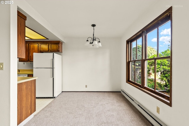 12665 SW Prince Edward Ct Unit A, Portland, OR 97224 - kitchen with freestanding refrigerator, a baseboard radiator, a chandelier, hanging light fixtures, and brown cabinets