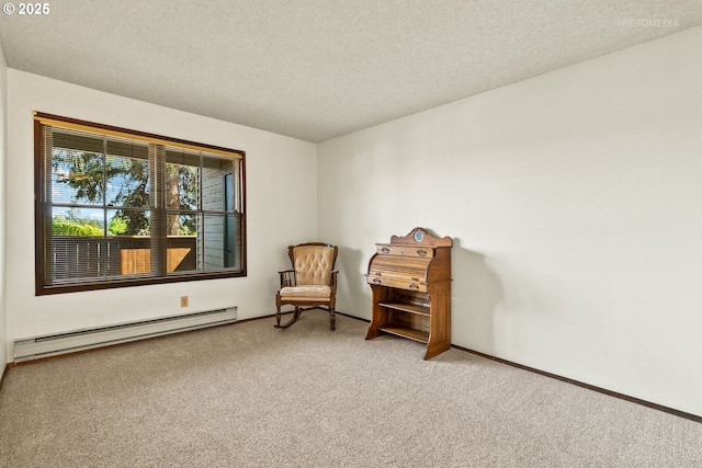 sitting room with a baseboard heating unit, carpet, a textured ceiling, and baseboards