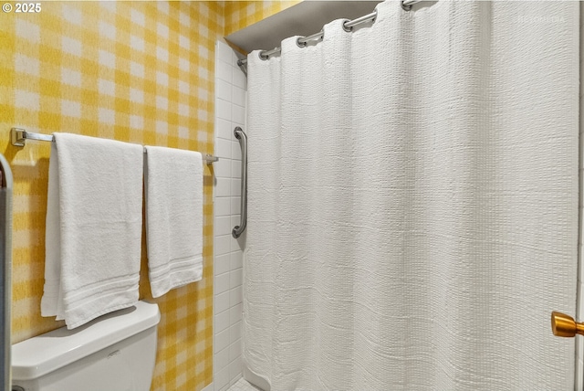 bathroom featuring wallpapered walls, toilet, and a shower with curtain