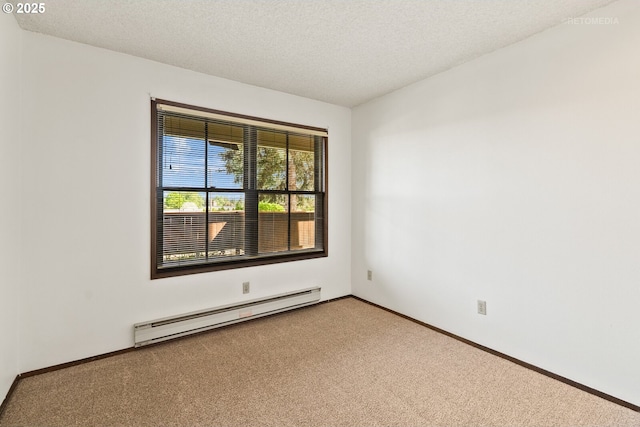 carpeted spare room with a baseboard radiator, baseboards, and a textured ceiling