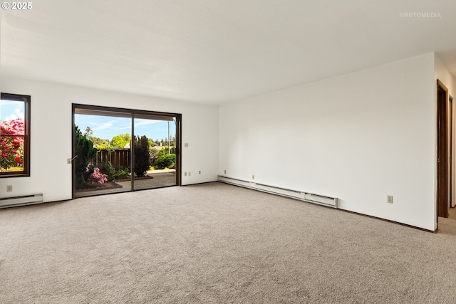 spare room with baseboard heating, carpet flooring, baseboards, and a baseboard radiator