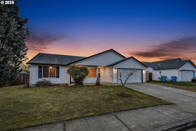 single story home with a garage and a lawn