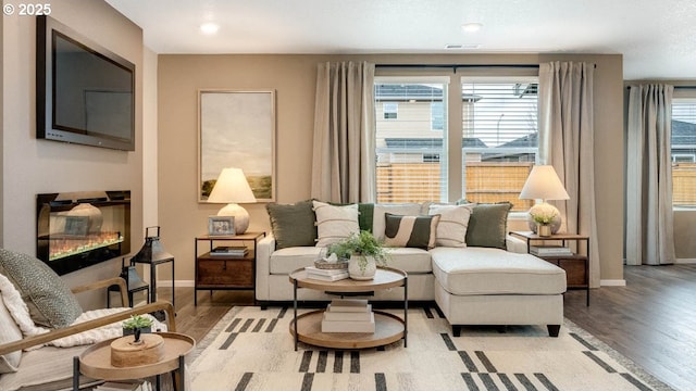 living room with light wood-type flooring and baseboards